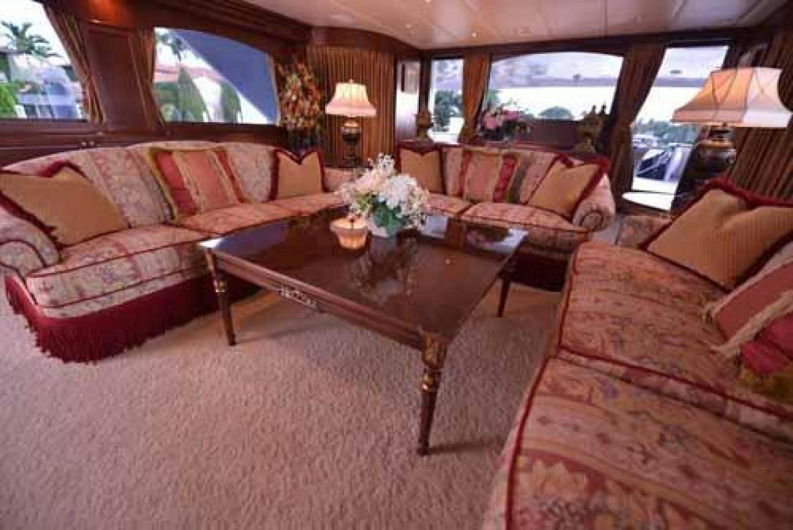 a living room with a table and couches aboard UTOPIA III Yacht for Sale