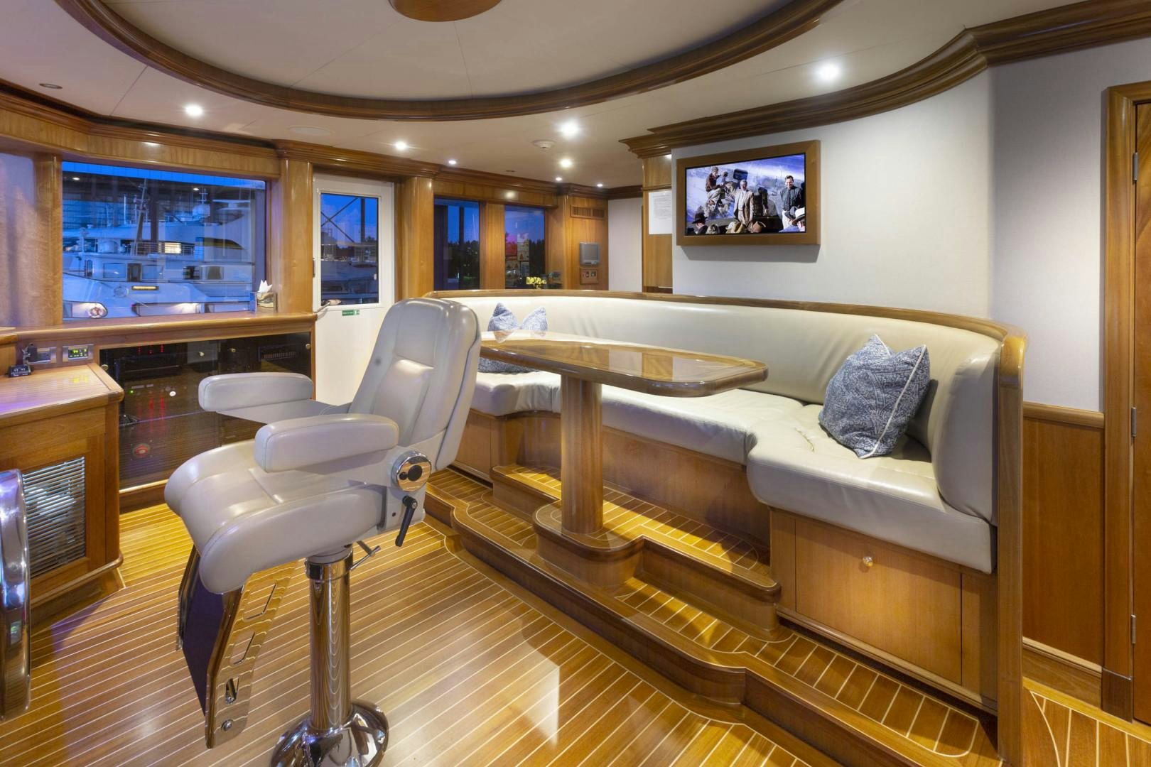a living room with a couch and a table aboard FAR FROM IT Yacht for Sale
