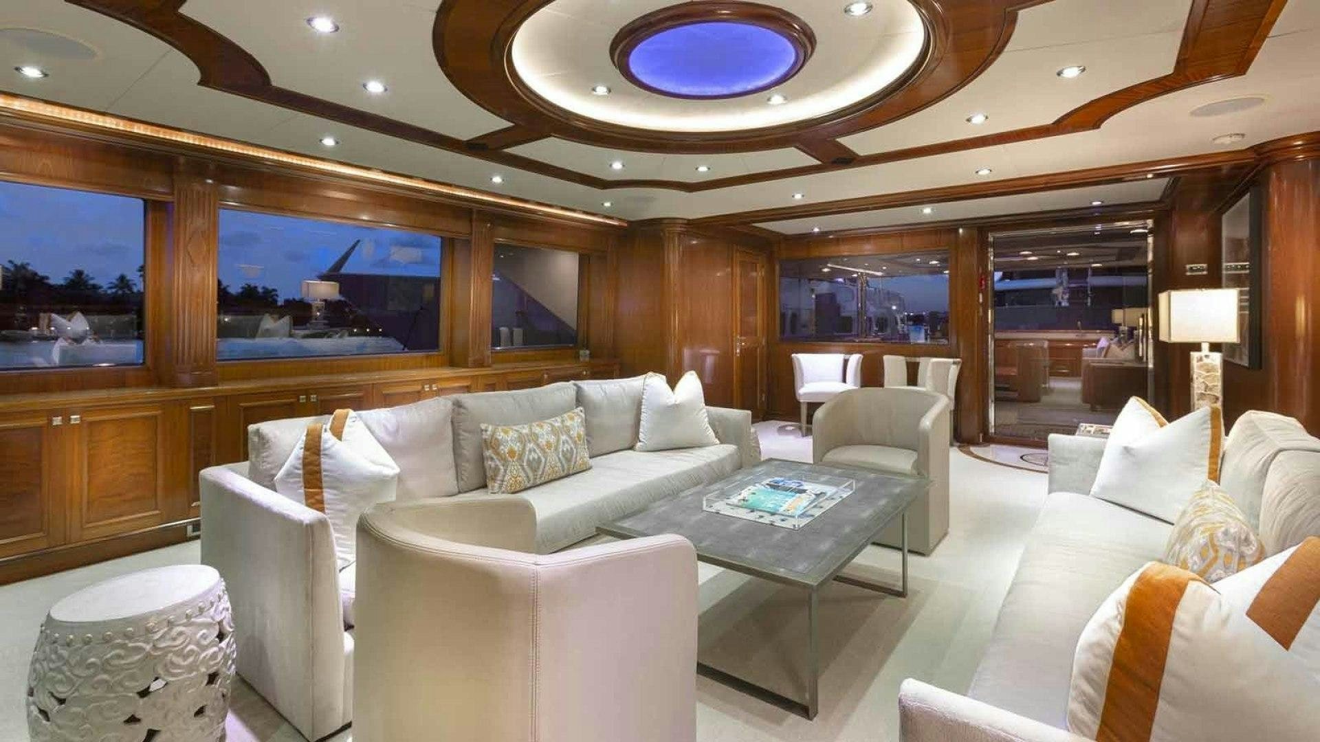 a living room with a large mirror aboard FAR FROM IT Yacht for Sale