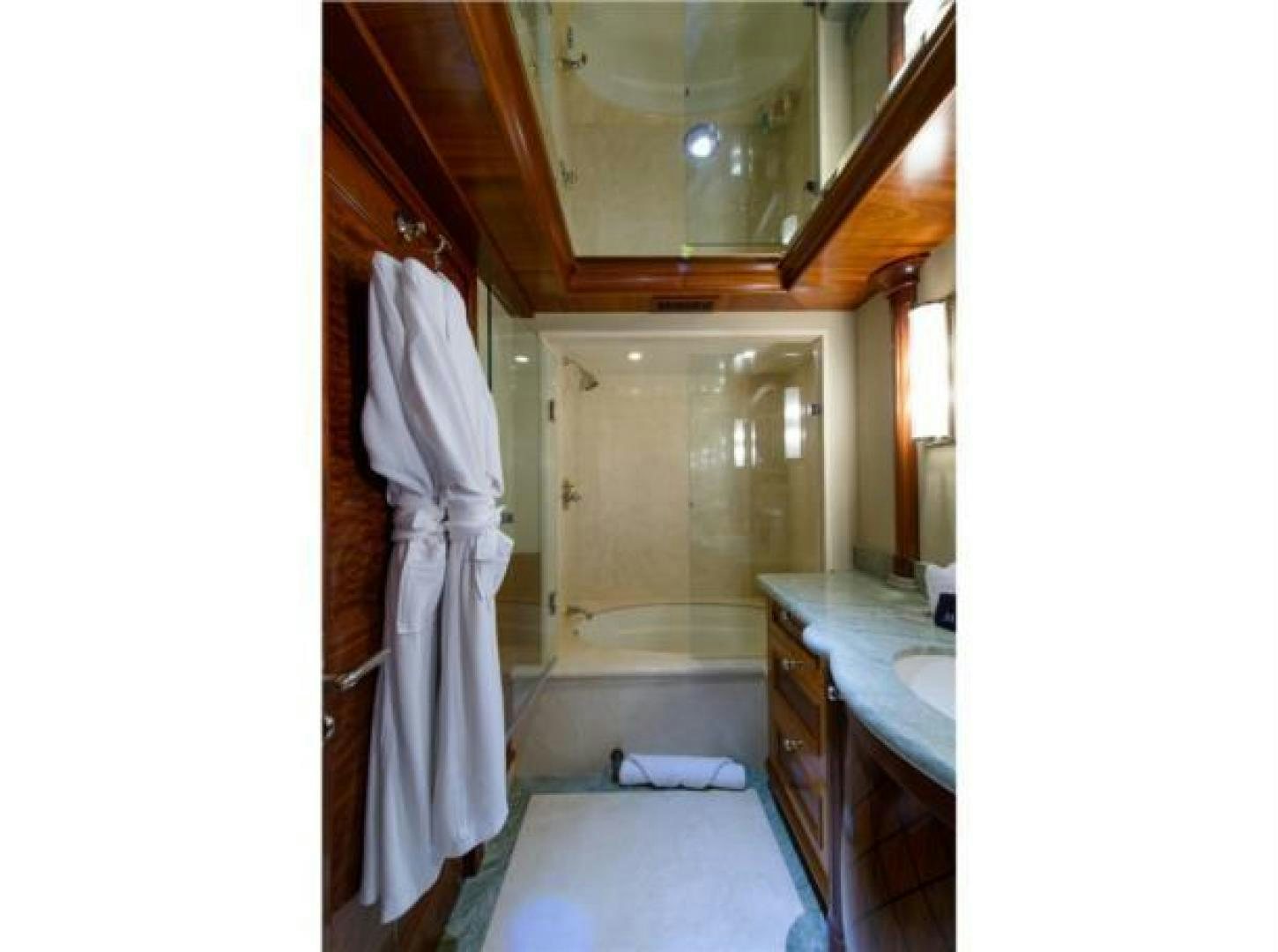 a bathroom with a sink and a mirror aboard FAR FROM IT Yacht for Sale