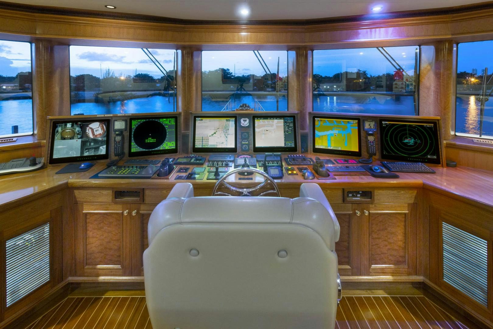 a white chair in front of a computer desk with a large window aboard FAR FROM IT Yacht for Sale