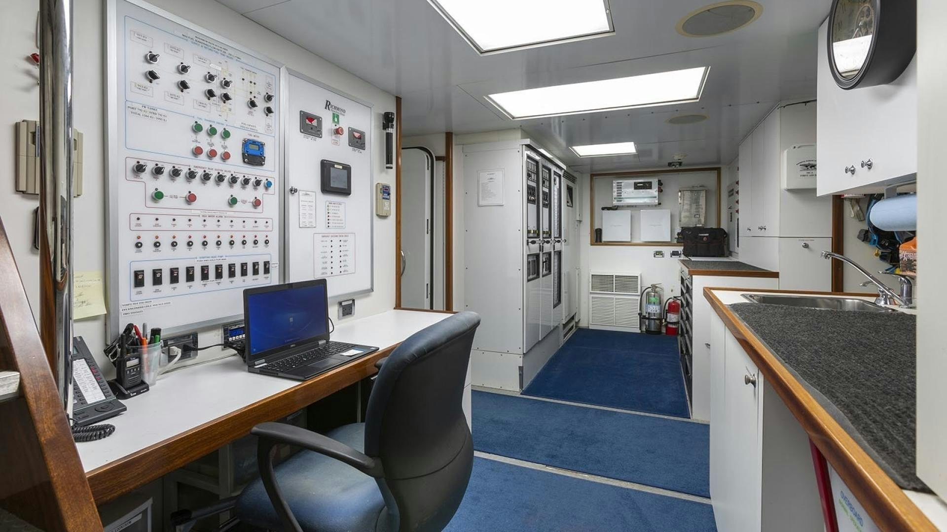 a room with a desk and a computer aboard FAR FROM IT Yacht for Sale