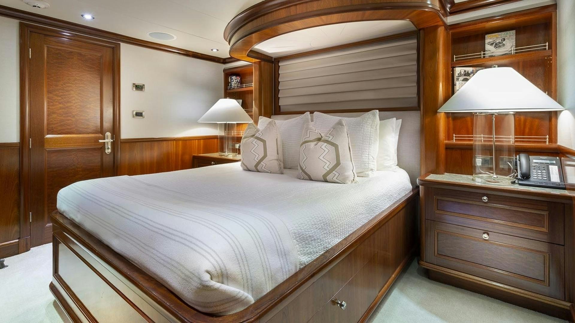 a bed with a white sheet and pillows aboard FAR FROM IT Yacht for Sale
