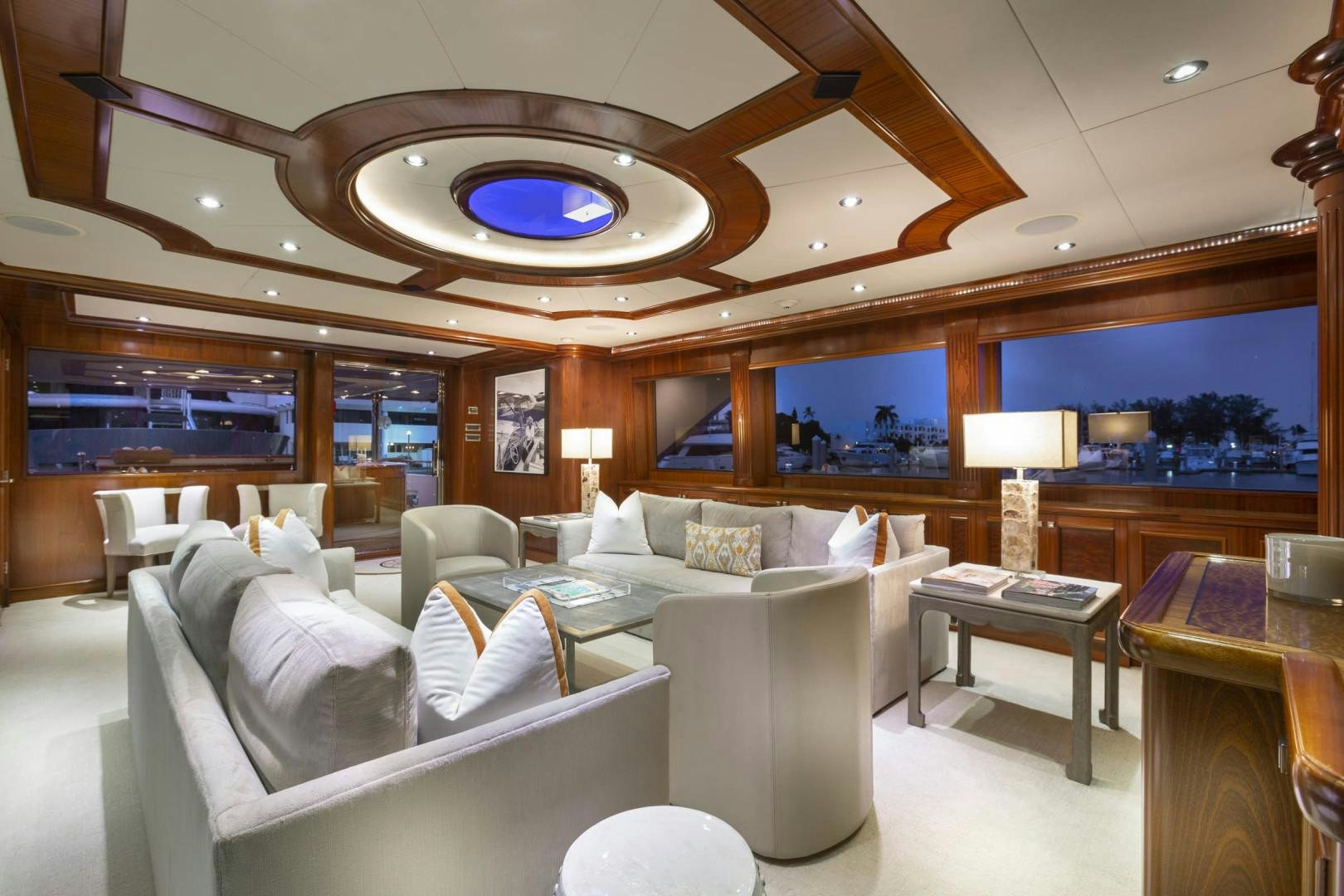 a large room with couches and a table aboard FAR FROM IT Yacht for Sale