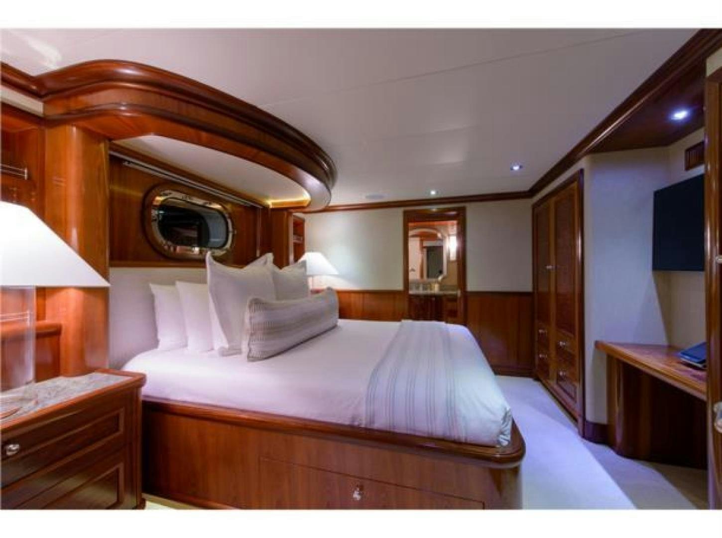 a hotel room with a bed and a mirror aboard FAR FROM IT Yacht for Sale