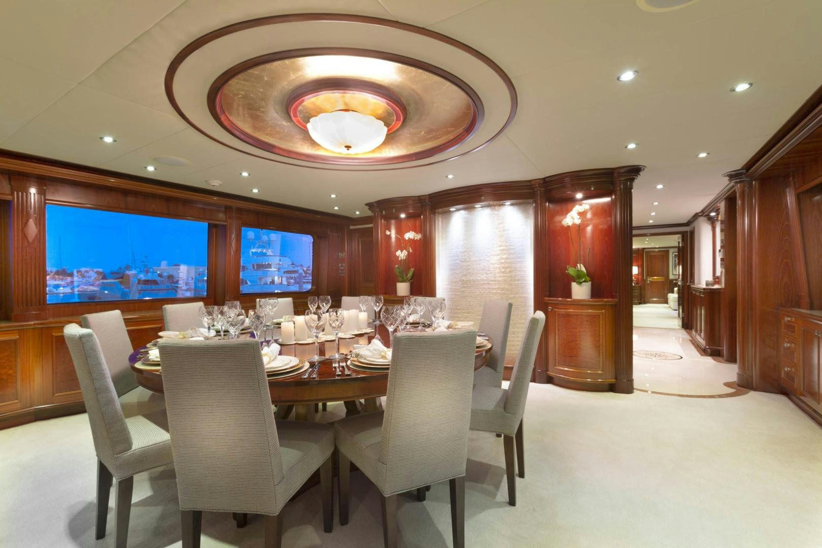 a large room with a table and chairs aboard FAR FROM IT Yacht for Sale
