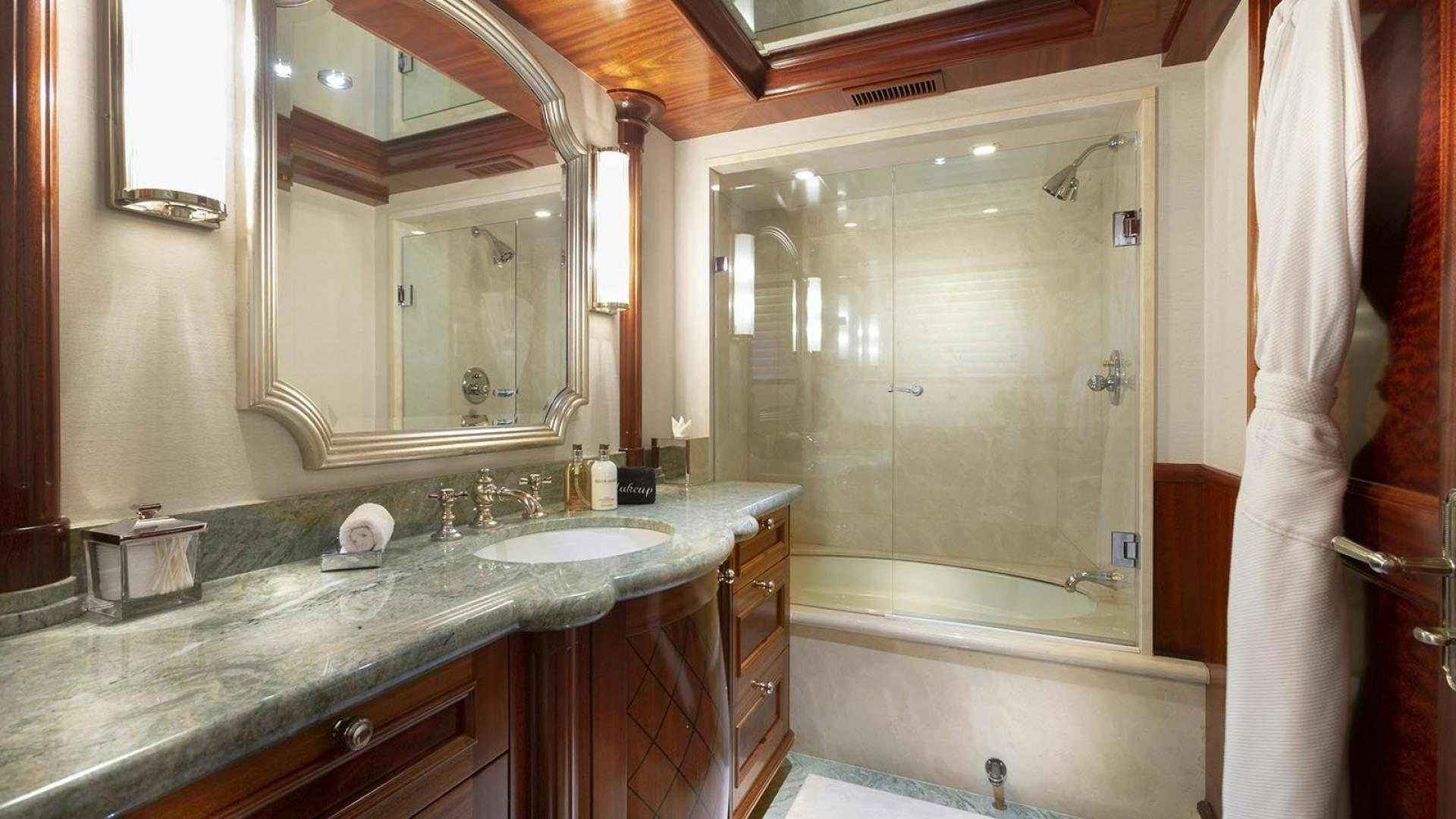 a bathroom with a large bathtub and sink aboard FAR FROM IT Yacht for Sale