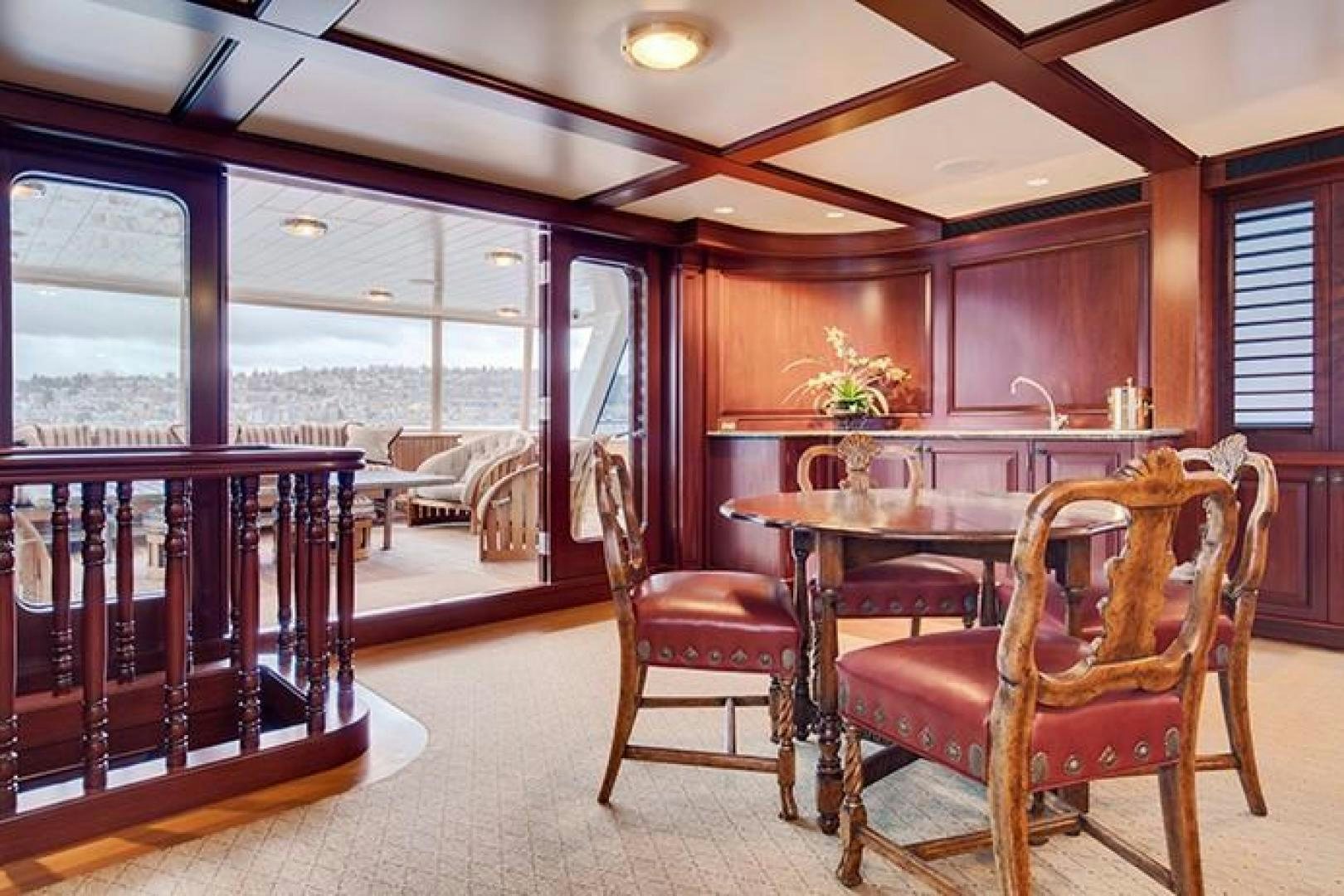 a dining room with a view of the ocean aboard MARLINDA Yacht for Sale