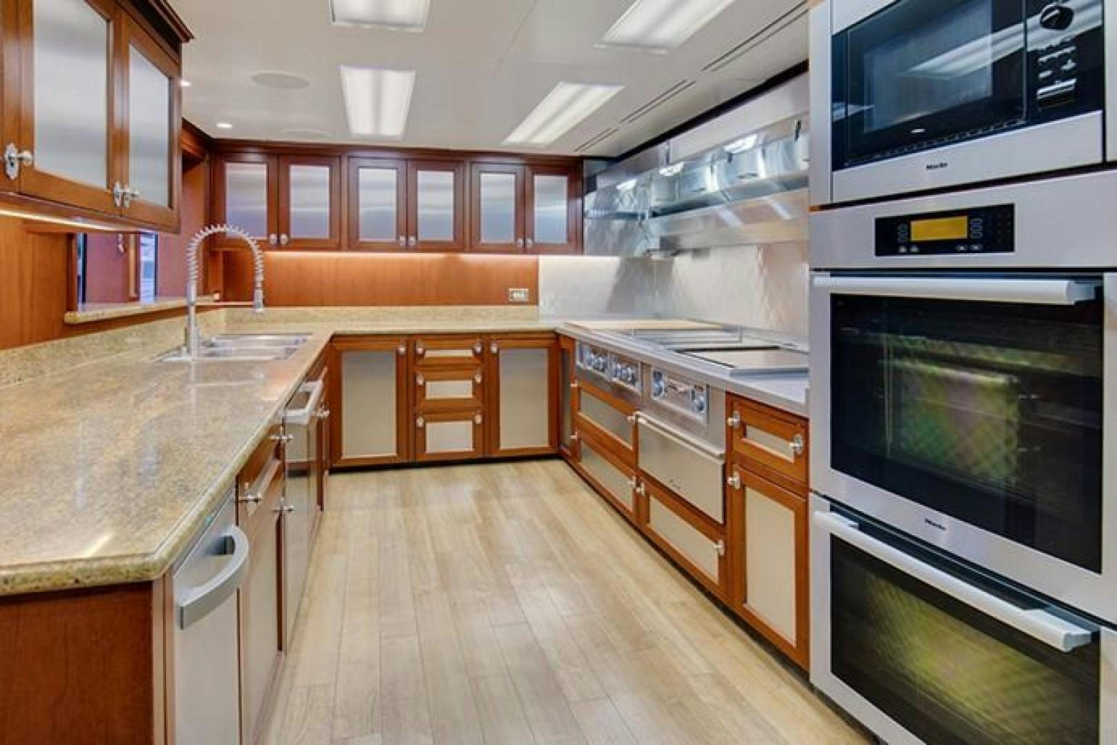 a kitchen with wooden cabinets aboard MARLINDA Yacht for Sale