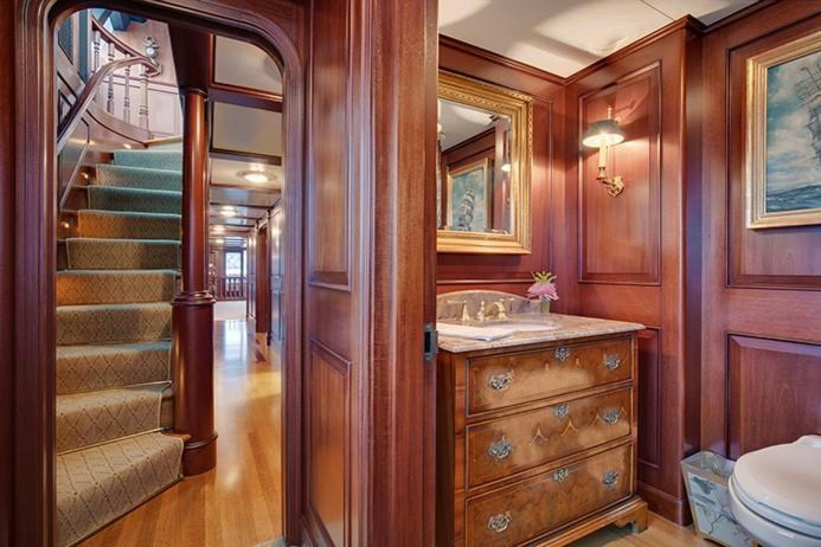 a bathroom with a wood door aboard MARLINDA Yacht for Sale