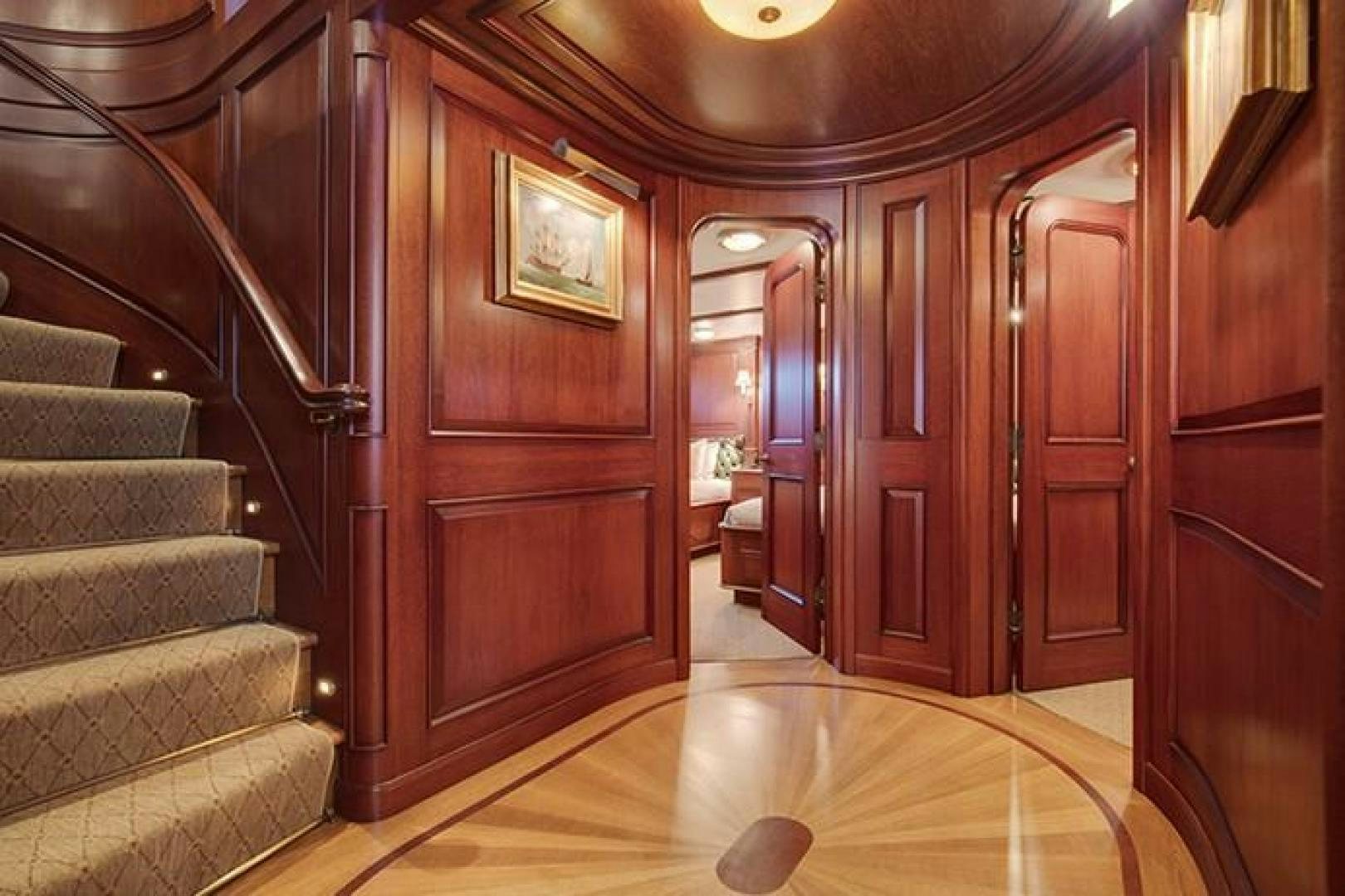 a living room with wood furniture aboard MARLINDA Yacht for Sale