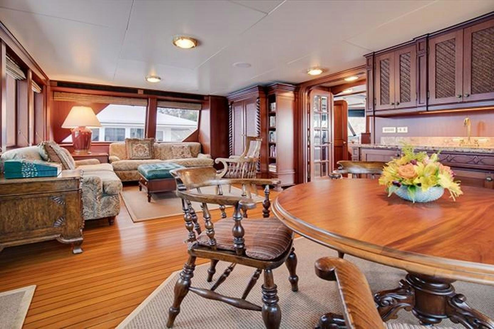 a living room with a table and couches aboard MARLINDA Yacht for Sale