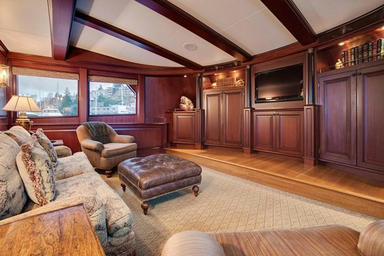 a living room with a large wood cabinet and a television aboard MARLINDA Yacht for Sale