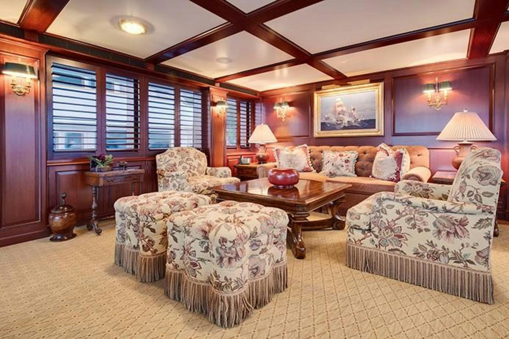 a living room with couches and a table aboard MARLINDA Yacht for Sale