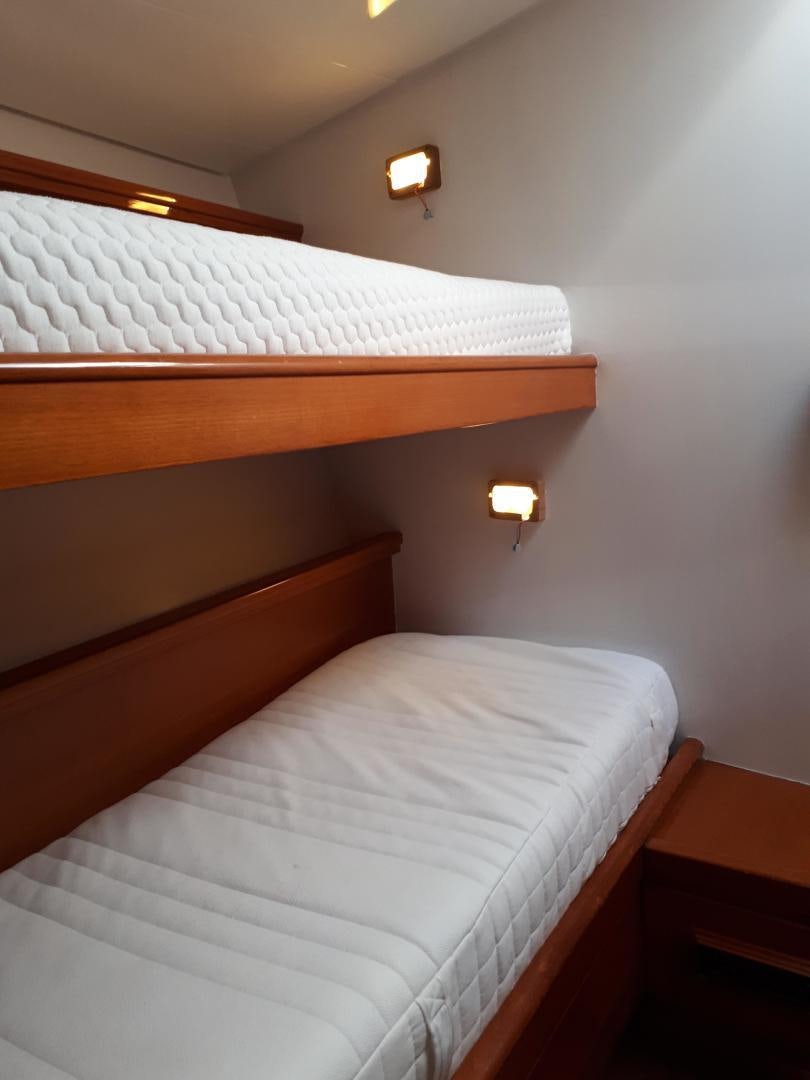 a bed with a white sheet aboard LATITUDE Yacht for Sale