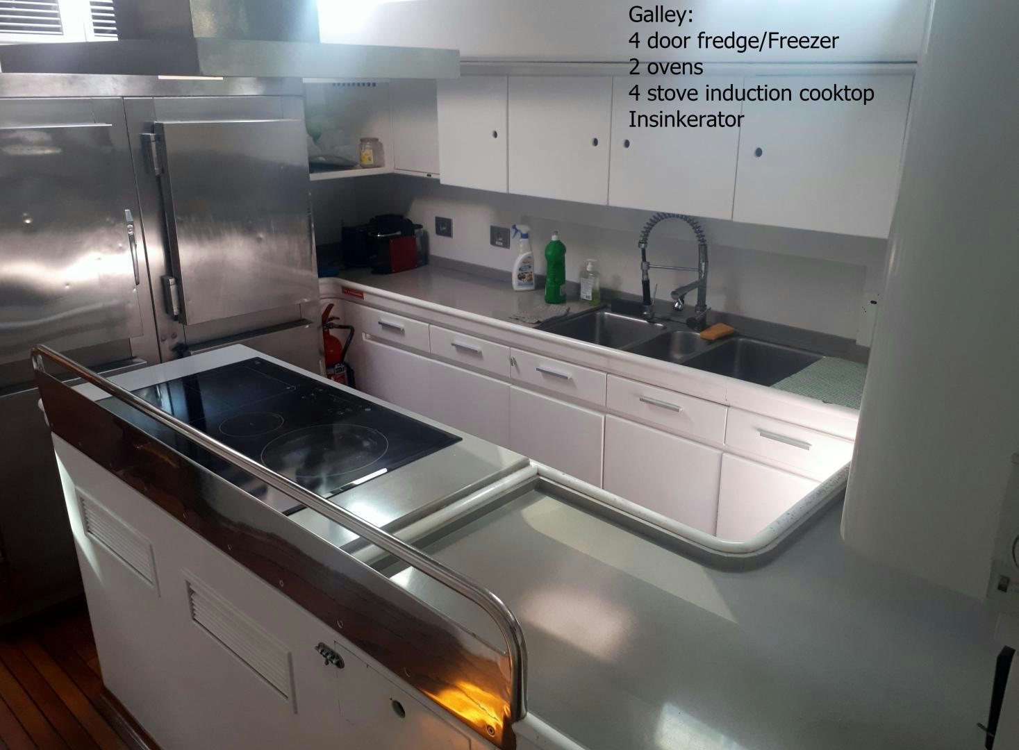 a kitchen with a stove and sink aboard LATITUDE Yacht for Sale