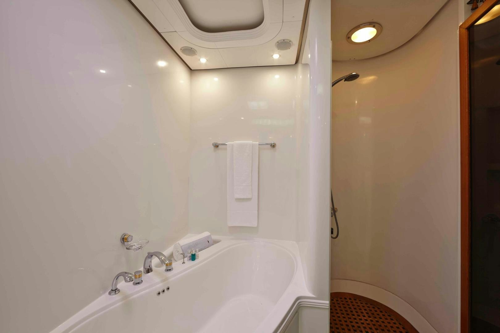 a bathtub and sink in a bathroom aboard LATITUDE Yacht for Sale