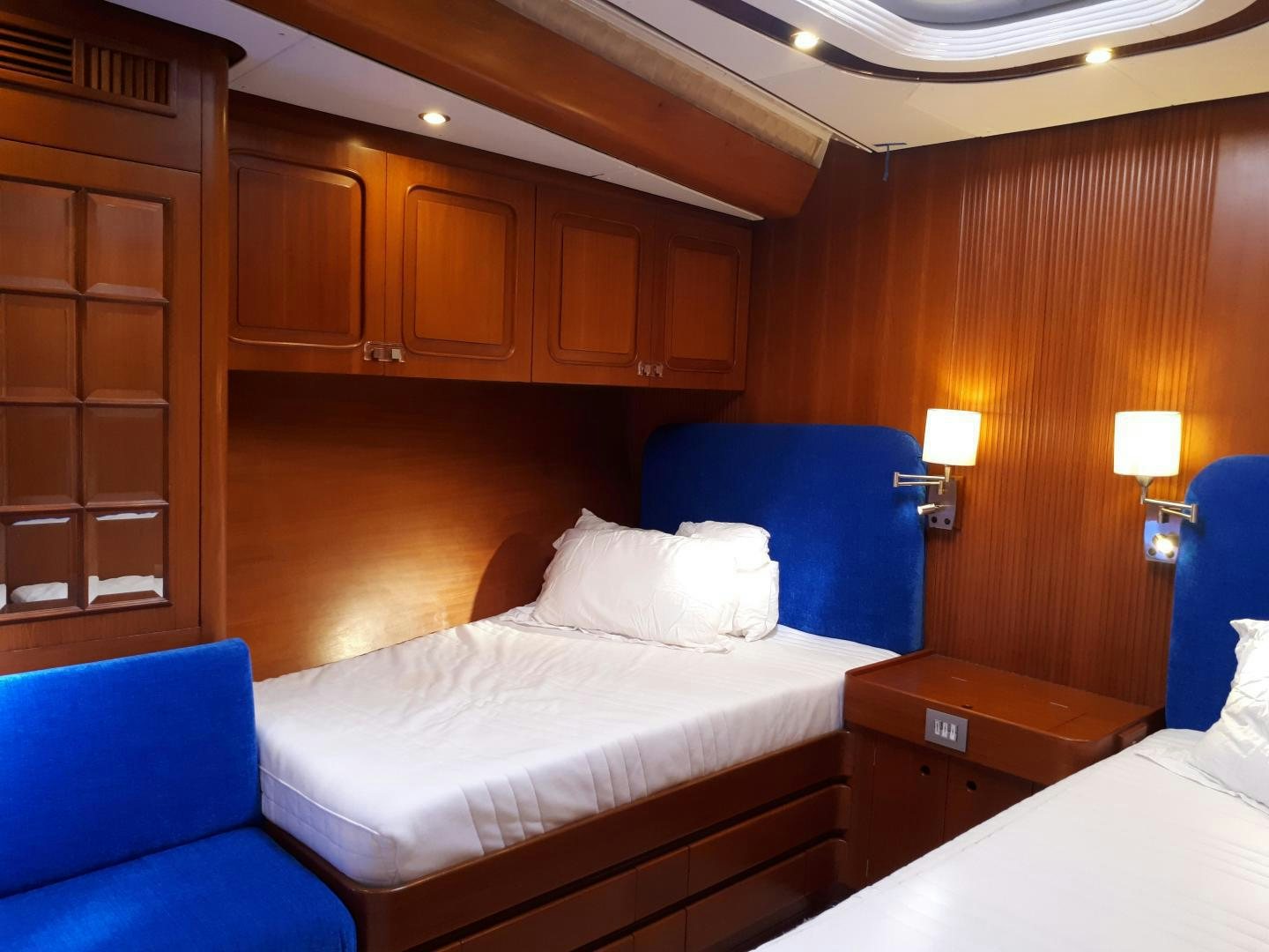 a room with a bed and a desk aboard LATITUDE Yacht for Sale