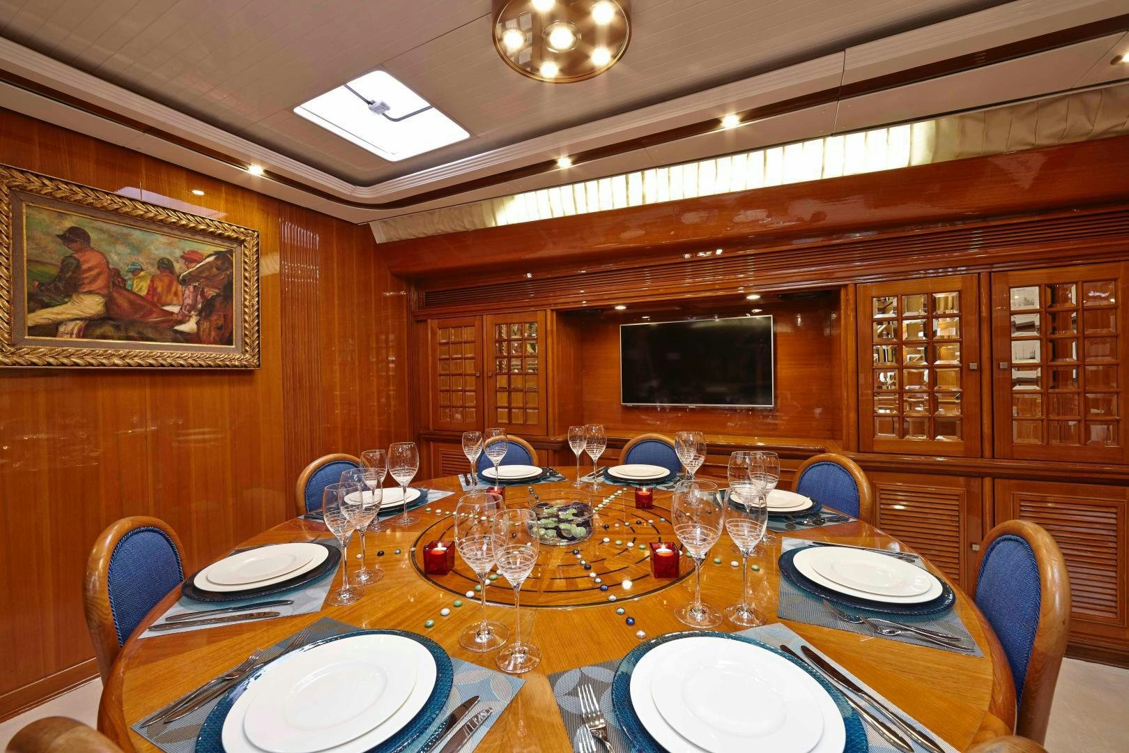 a table with plates and glasses aboard LATITUDE Yacht for Sale