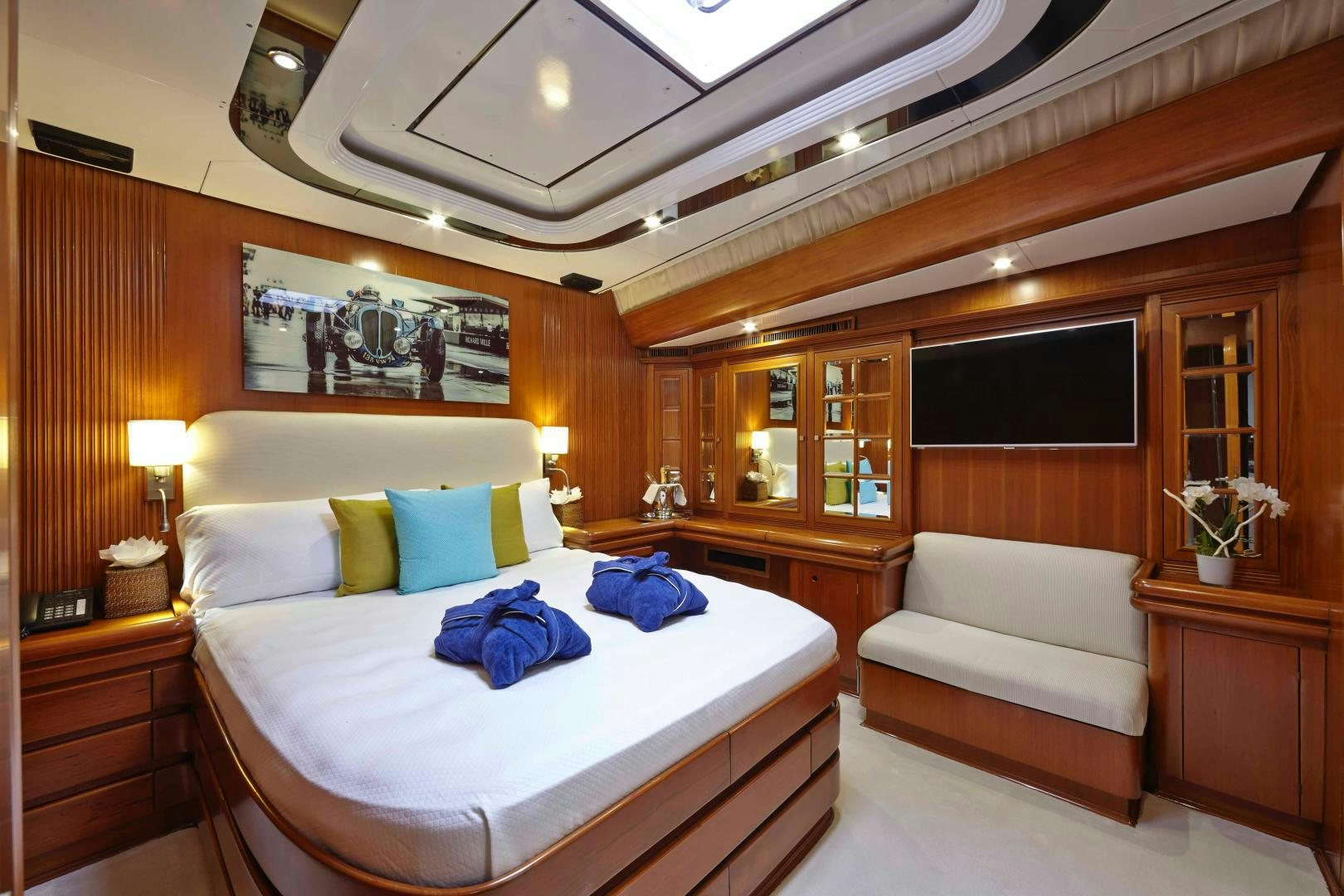 a room with a bed and a couch aboard LATITUDE Yacht for Sale