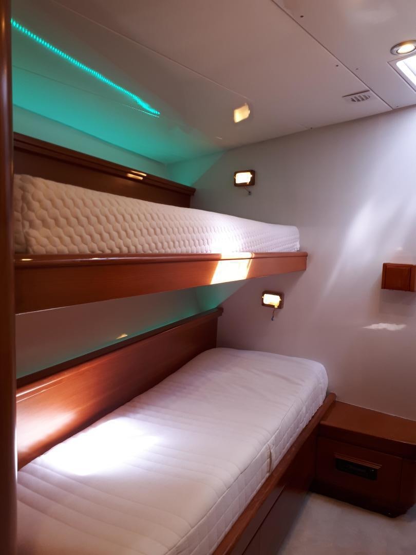 a room with a bed and a desk aboard LATITUDE Yacht for Sale