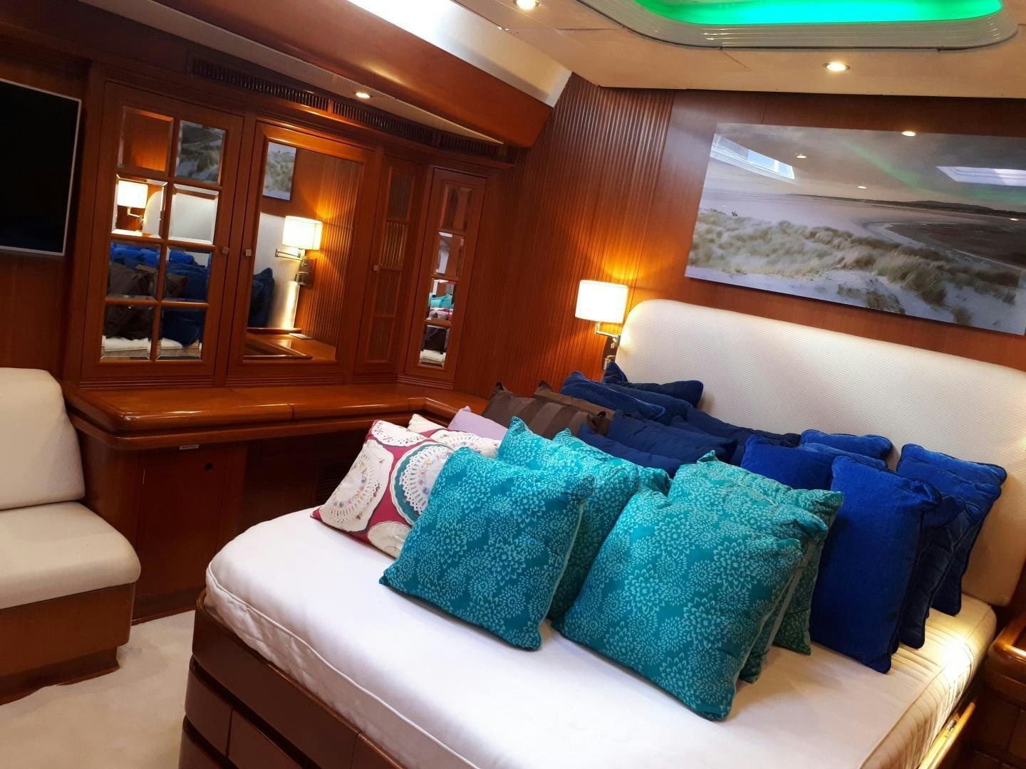 a room with a bed and a chair aboard LATITUDE Yacht for Sale