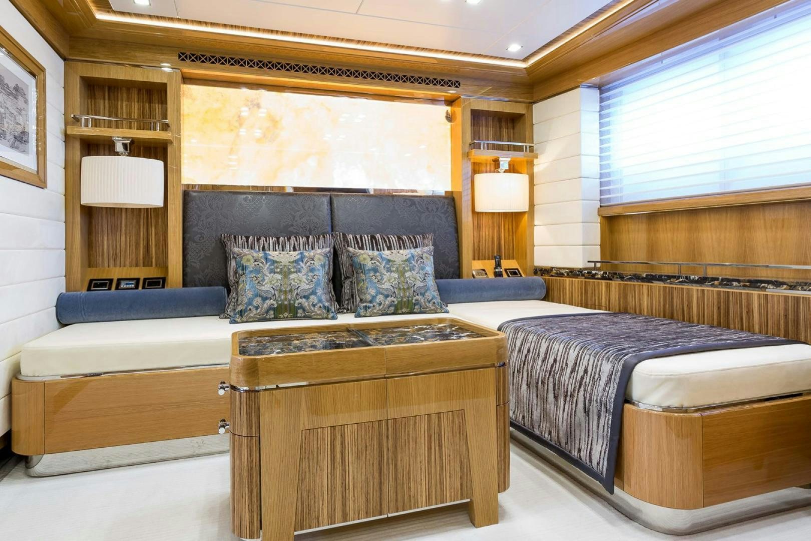 a room with a bed and a couch aboard VIATORIS Yacht for Sale