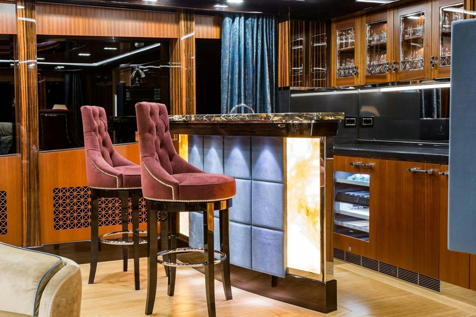 a couple of pink chairs in a kitchen aboard VIATORIS Yacht for Sale