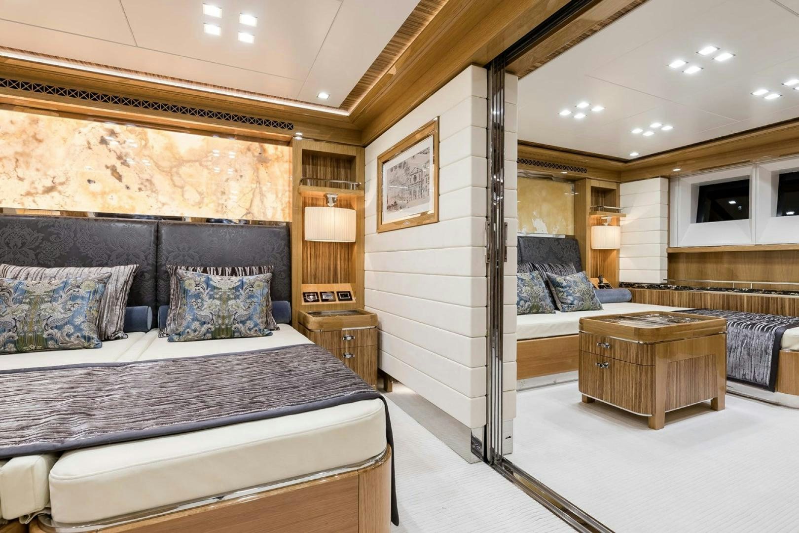 a room with a bed and a couch aboard VIATORIS Yacht for Sale