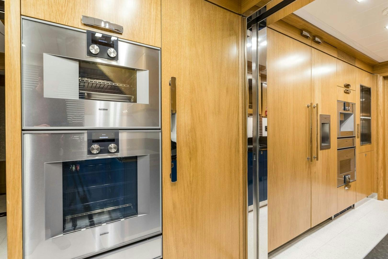 a kitchen with wooden cabinets aboard VIATORIS Yacht for Sale