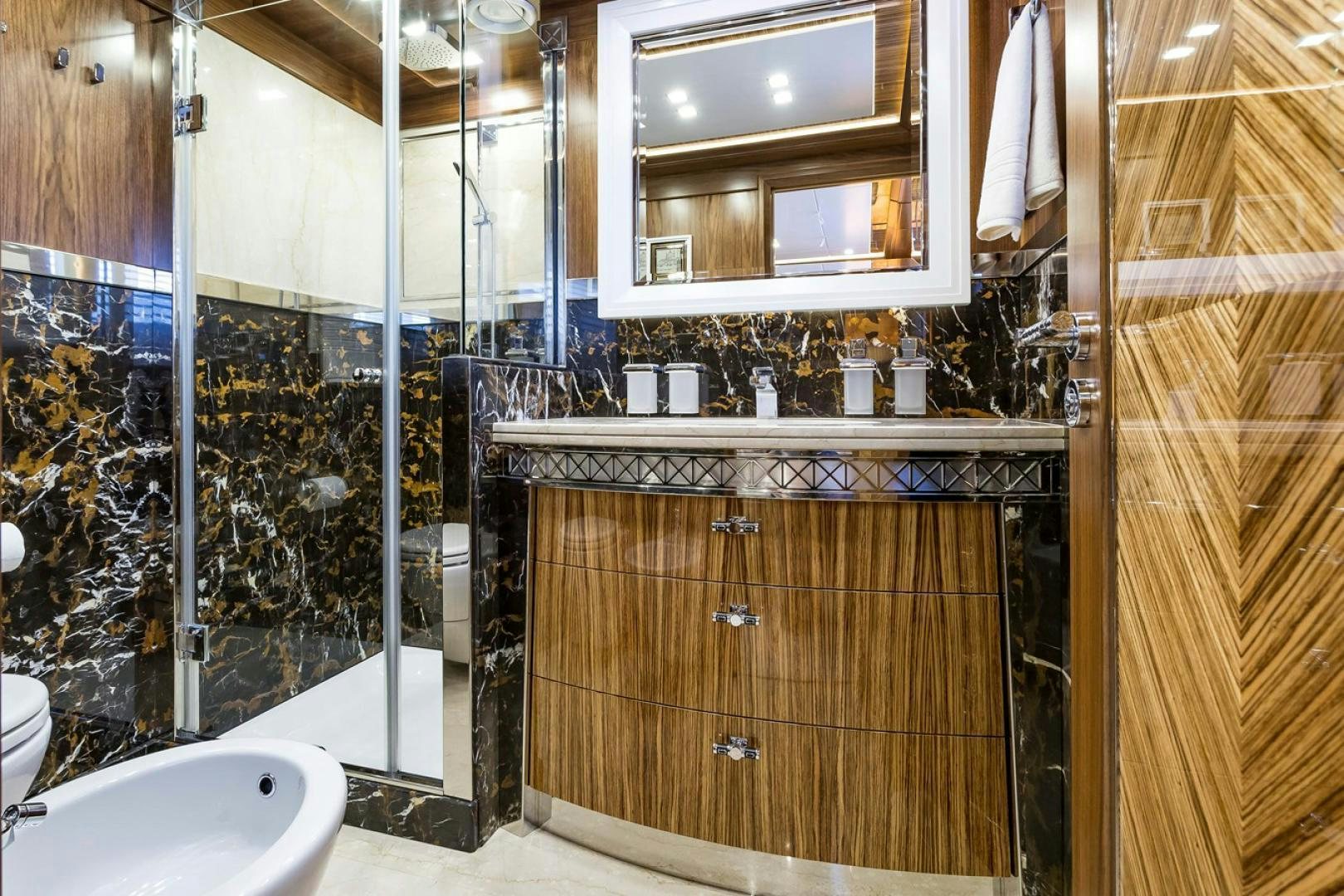a bathroom with a glass shower aboard VIATORIS Yacht for Sale