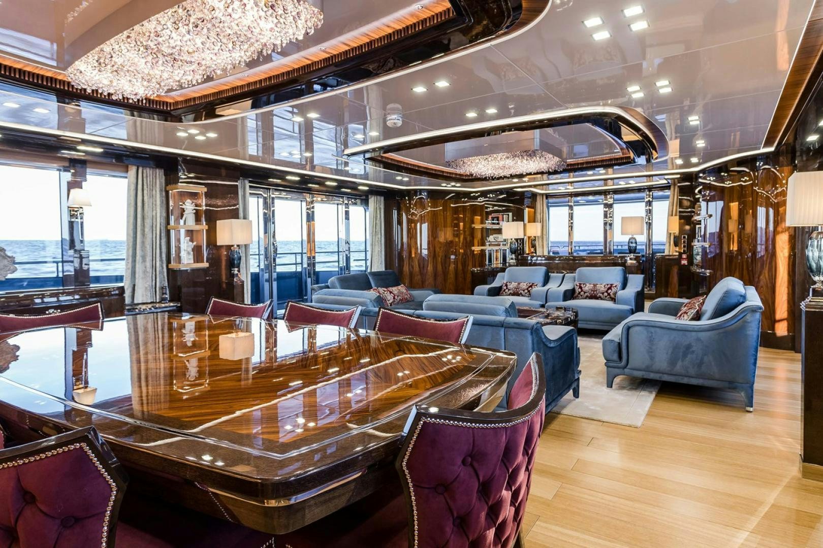 a large room with a table and chairs aboard VIATORIS Yacht for Sale