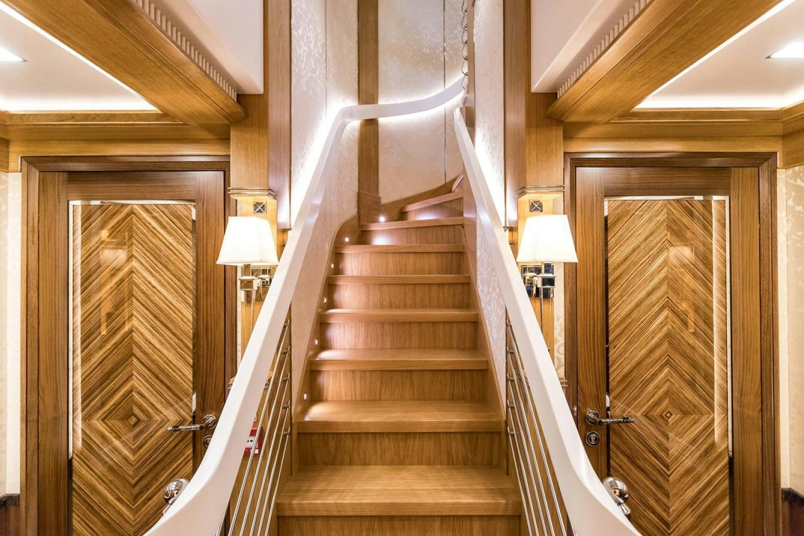 a wooden staircase in a house aboard VIATORIS Yacht for Sale