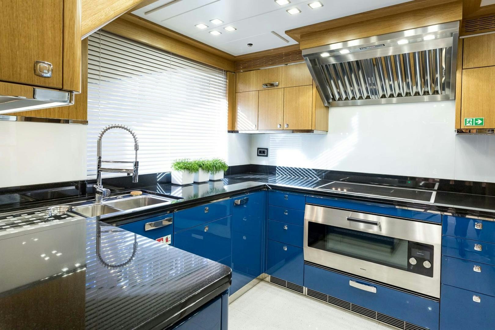 a kitchen with blue cabinets aboard VIATORIS Yacht for Sale