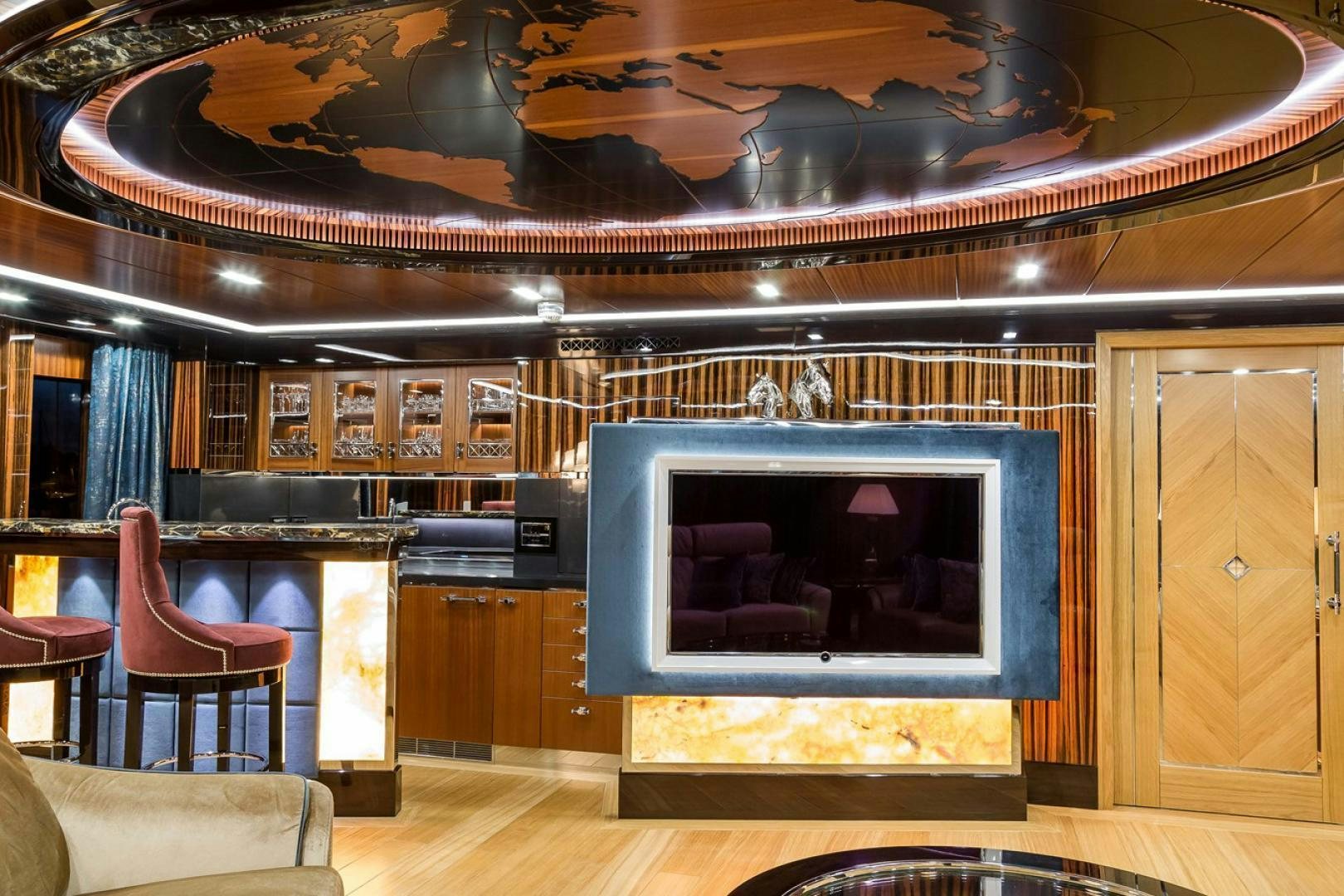 a room with a fireplace and a chair aboard VIATORIS Yacht for Sale