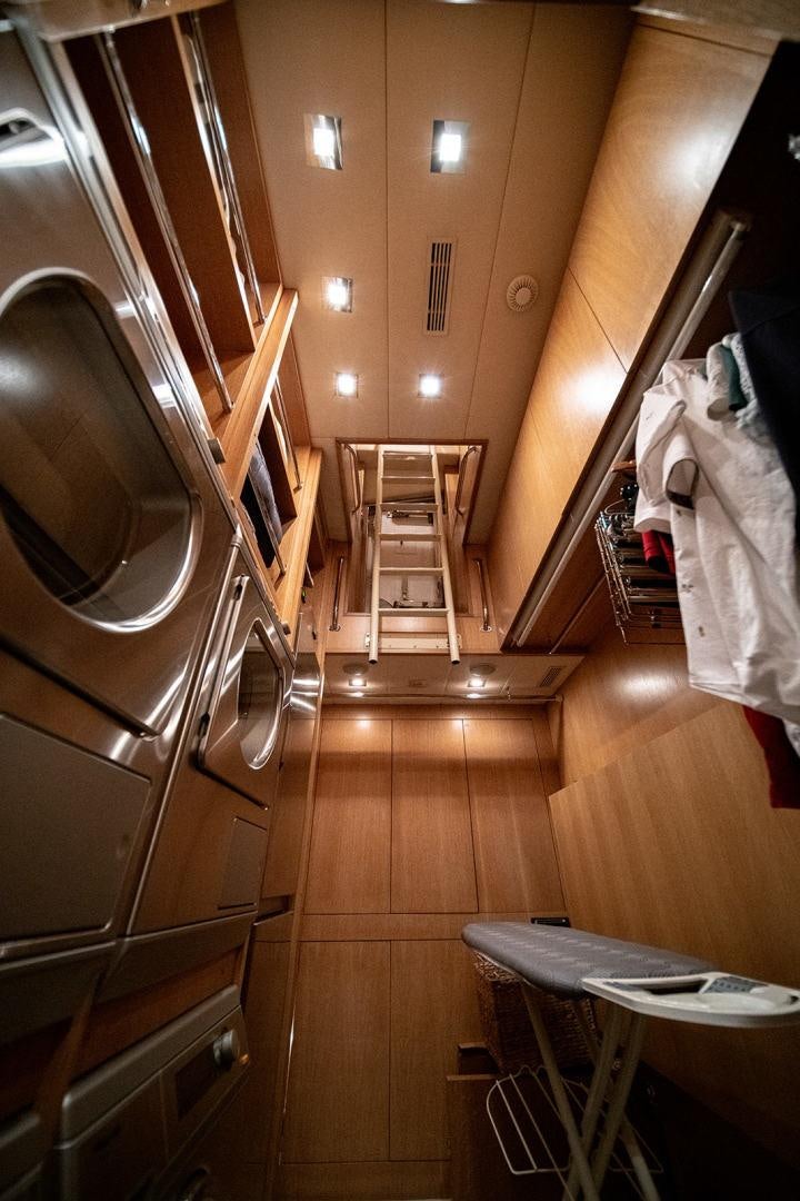a room with a mirror and a table and a chair aboard HARMONIC WAVES Yacht for Sale
