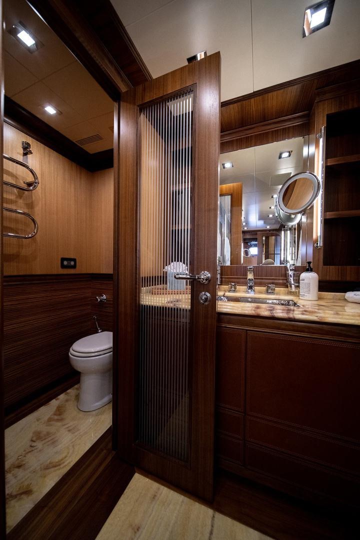 a bathroom with a glass shower door aboard HARMONIC WAVES Yacht for Sale