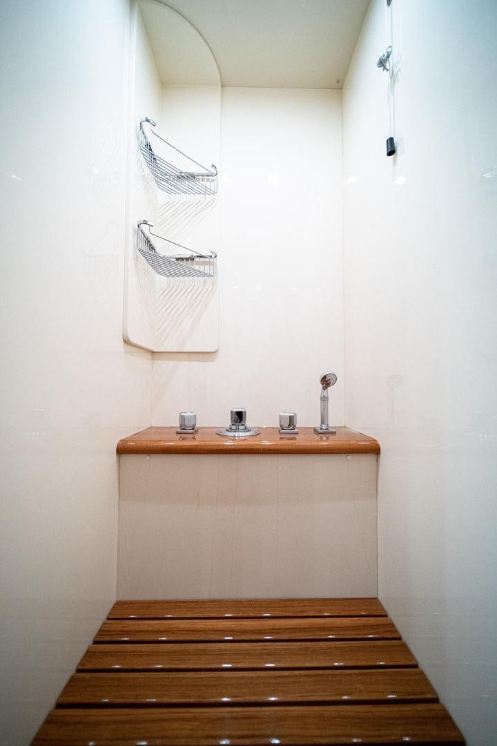 a wooden shelf with a light on it aboard HARMONIC WAVES Yacht for Sale