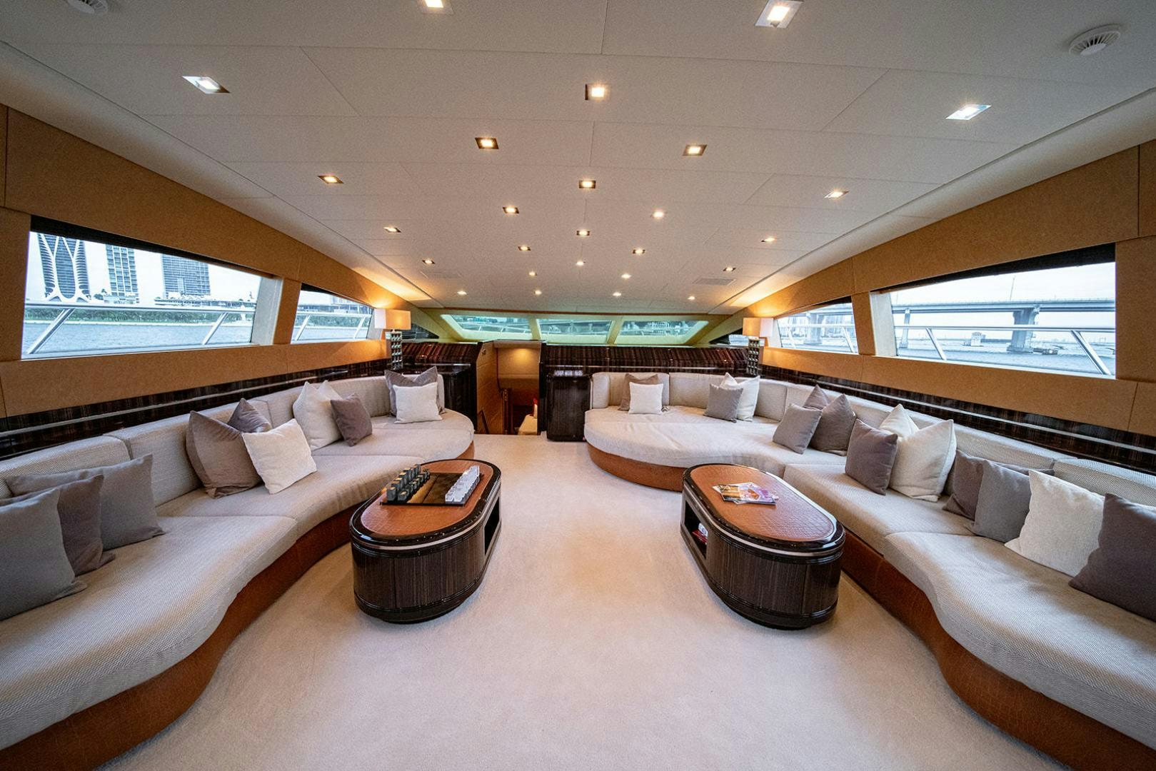 a large living room with a large bed and a table aboard HARMONIC WAVES Yacht for Sale