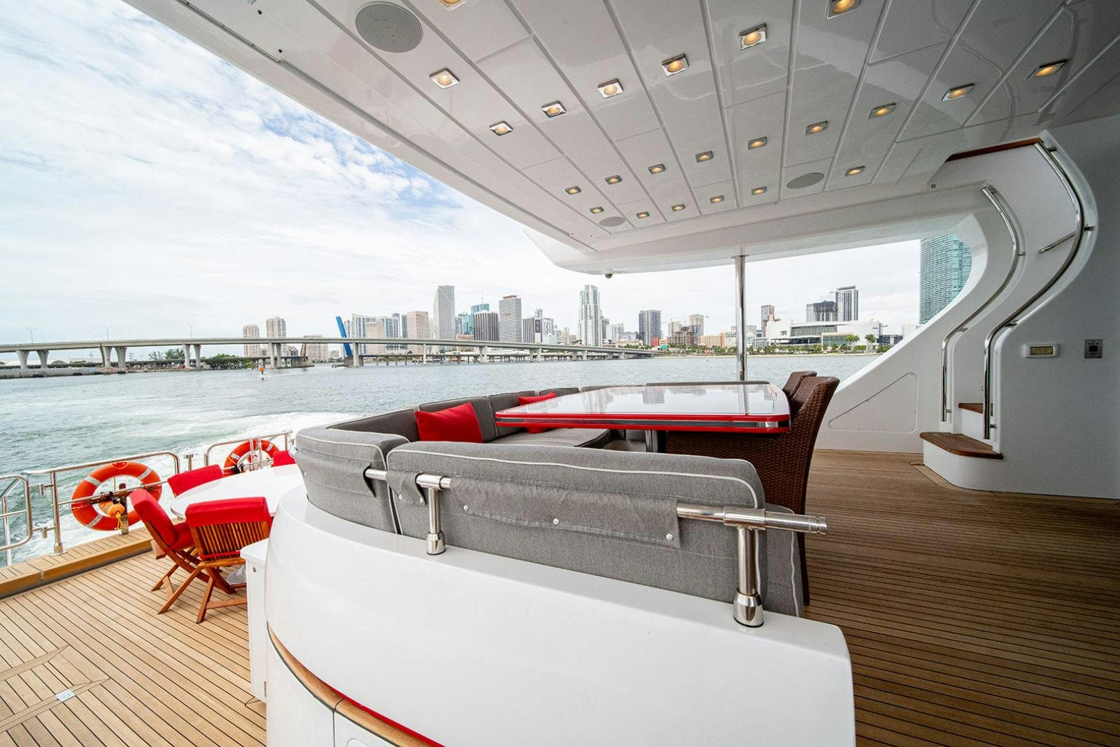 a deck with a pool and a city in the background aboard HARMONIC WAVES Yacht for Sale