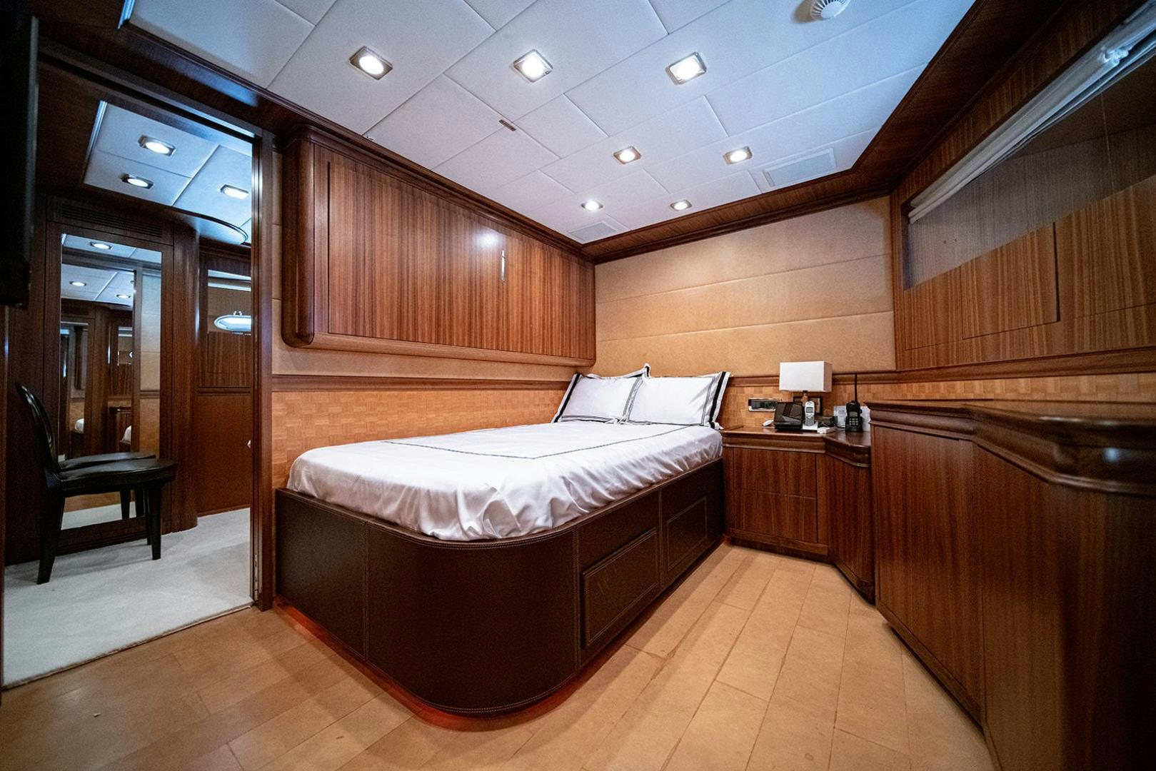 a room with a bed and a desk aboard HARMONIC WAVES Yacht for Sale
