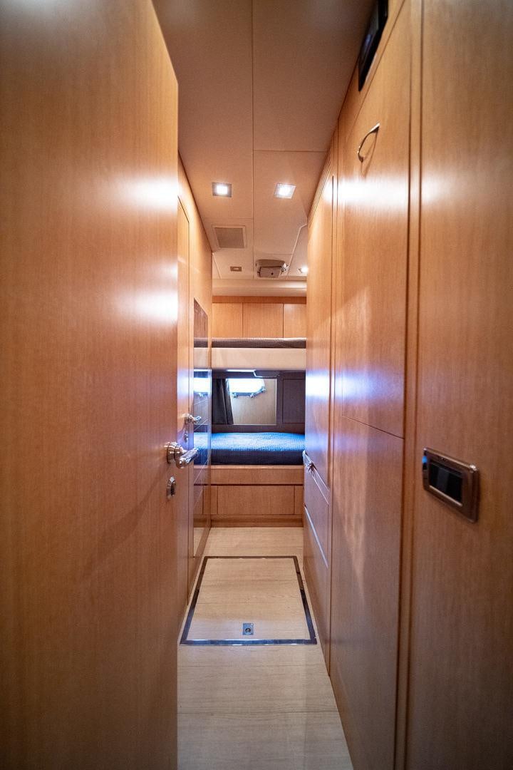 a hallway with a door and a mirror aboard HARMONIC WAVES Yacht for Sale