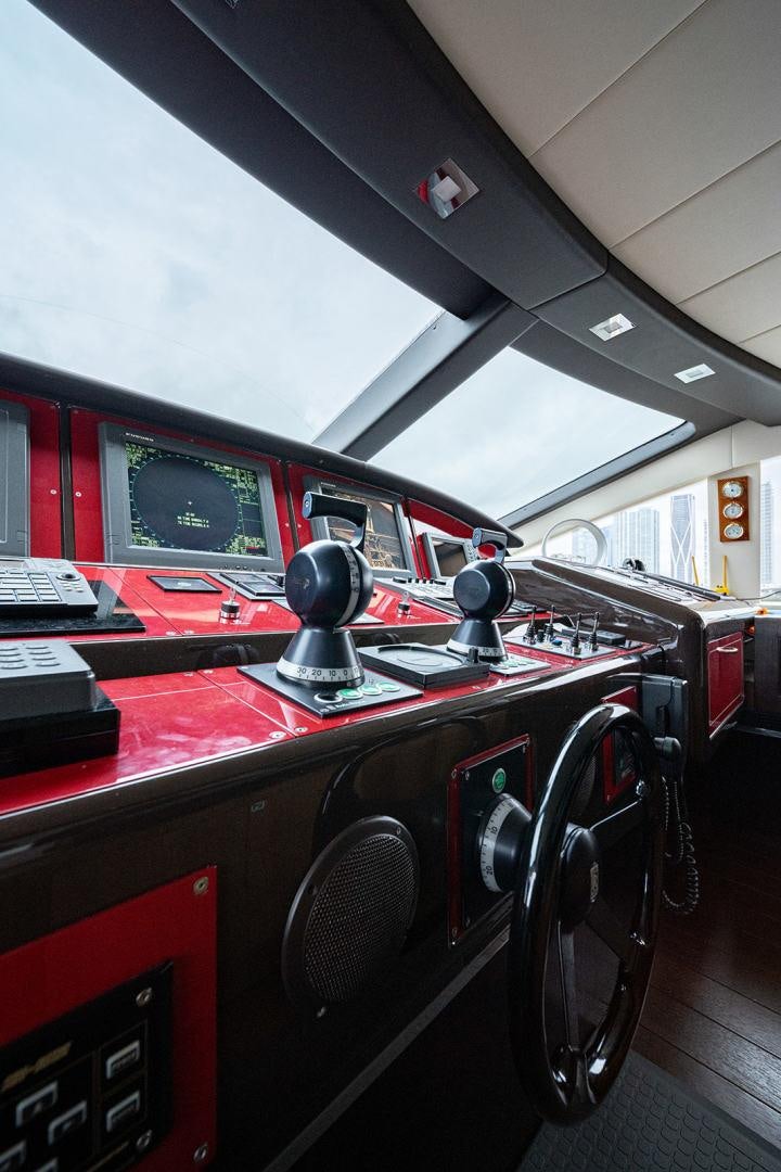 a red car with a round display aboard HARMONIC WAVES Yacht for Sale