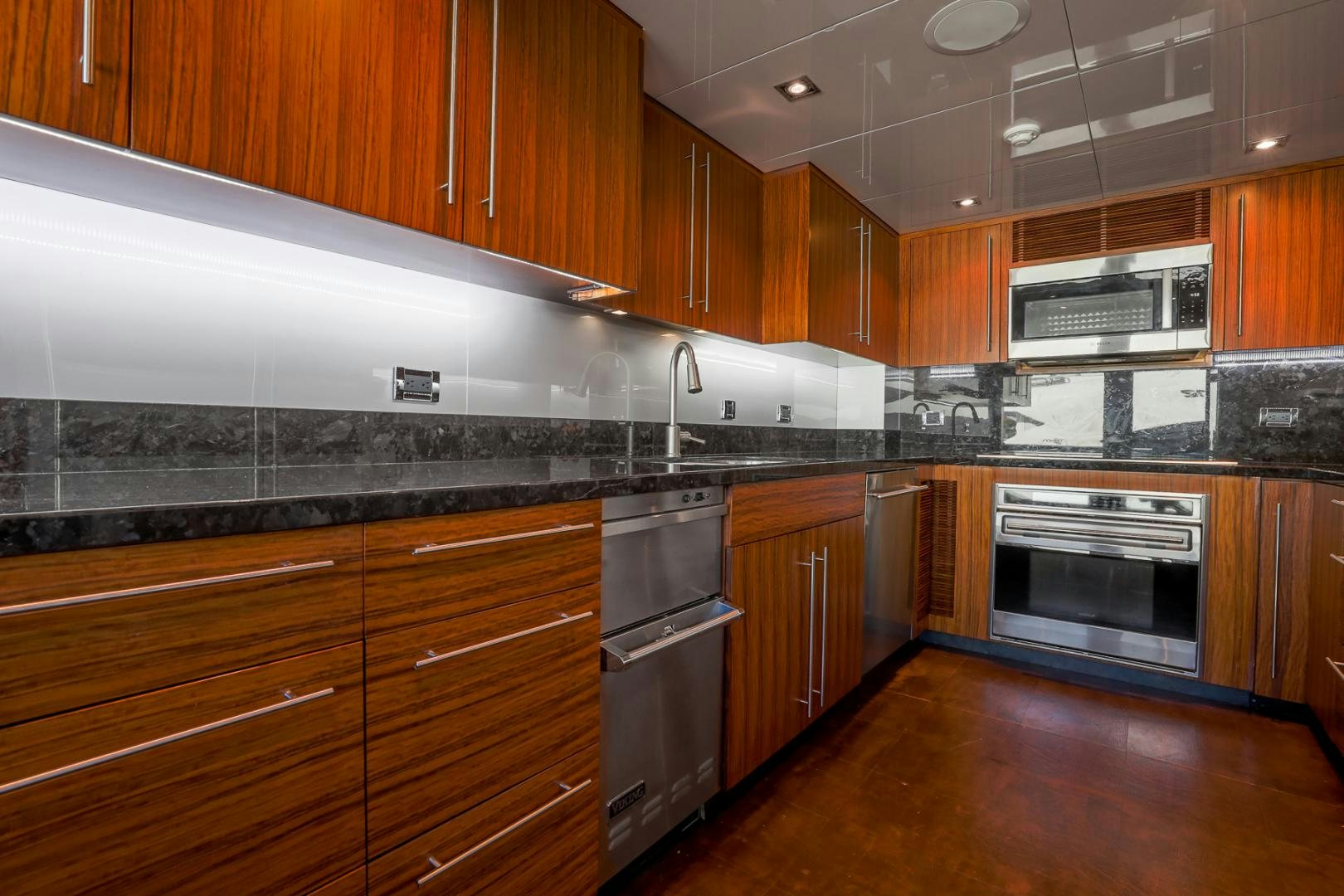 a kitchen with wooden cabinets aboard FUGITIVE *NAME RESERVED* Yacht for Sale