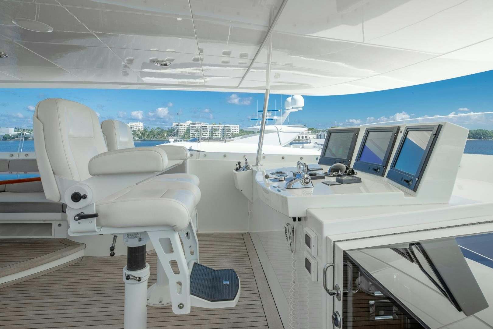 a white chair on a deck overlooking a city aboard FUGITIVE *NAME RESERVED* Yacht for Sale