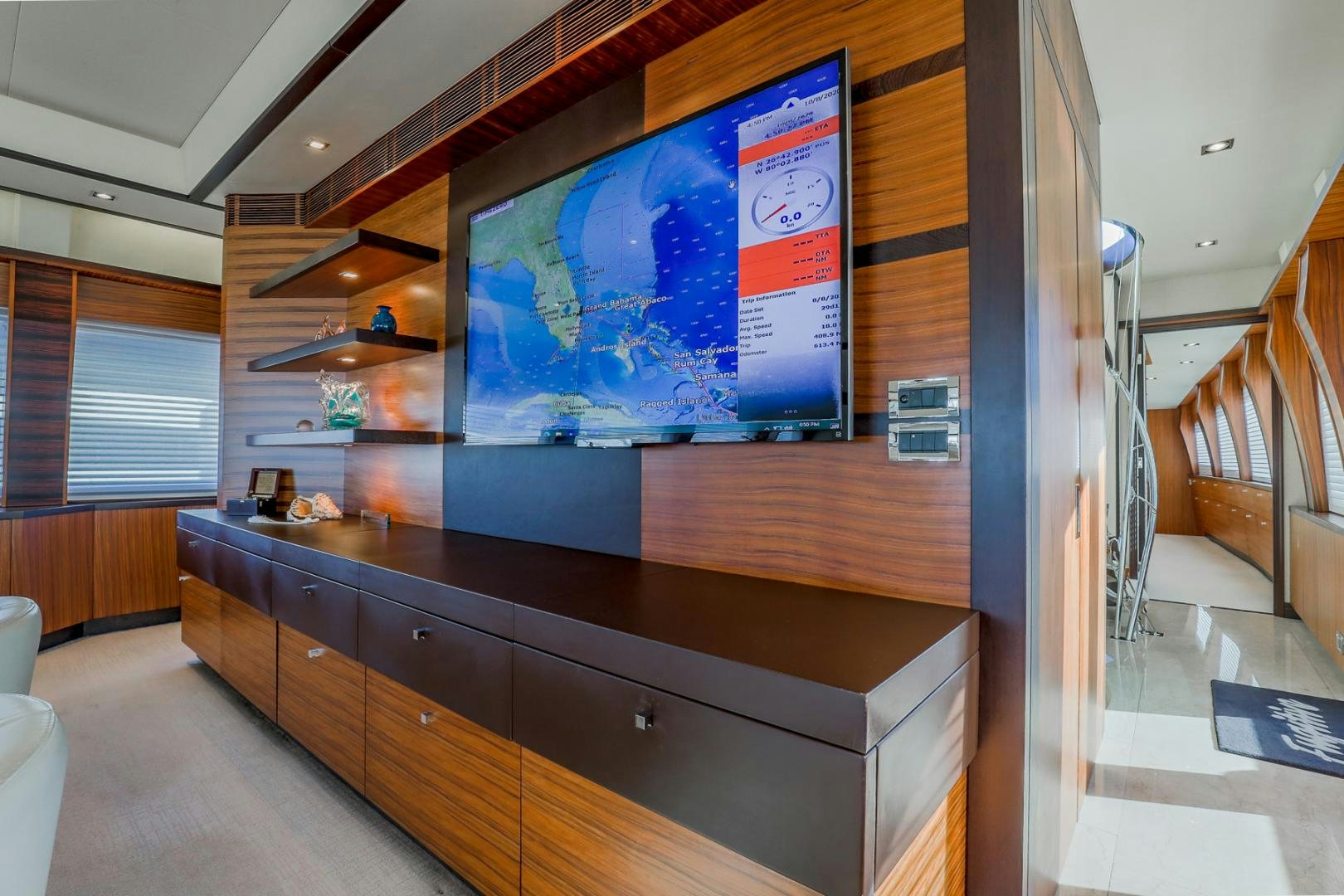 a room with a tv and a bookcase aboard FUGITIVE *NAME RESERVED* Yacht for Sale
