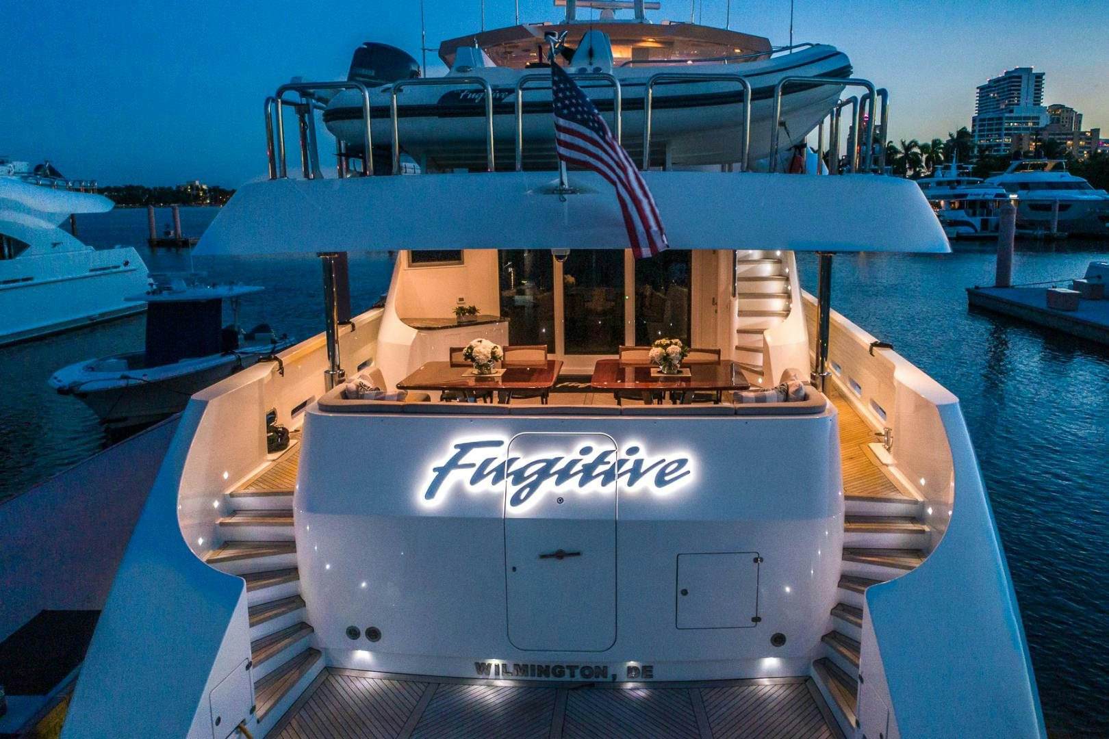 a boat with a flag on the front aboard FUGITIVE *NAME RESERVED* Yacht for Sale