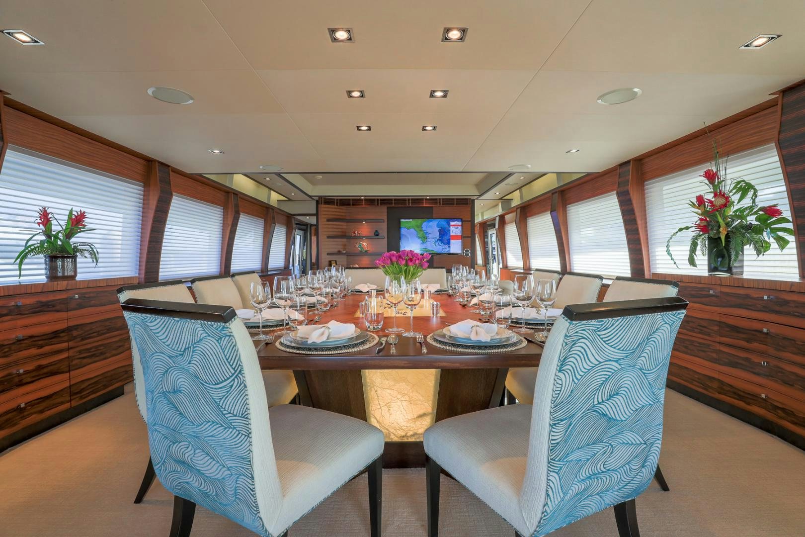 a large dining room with a large table and chairs aboard FUGITIVE *NAME RESERVED* Yacht for Sale
