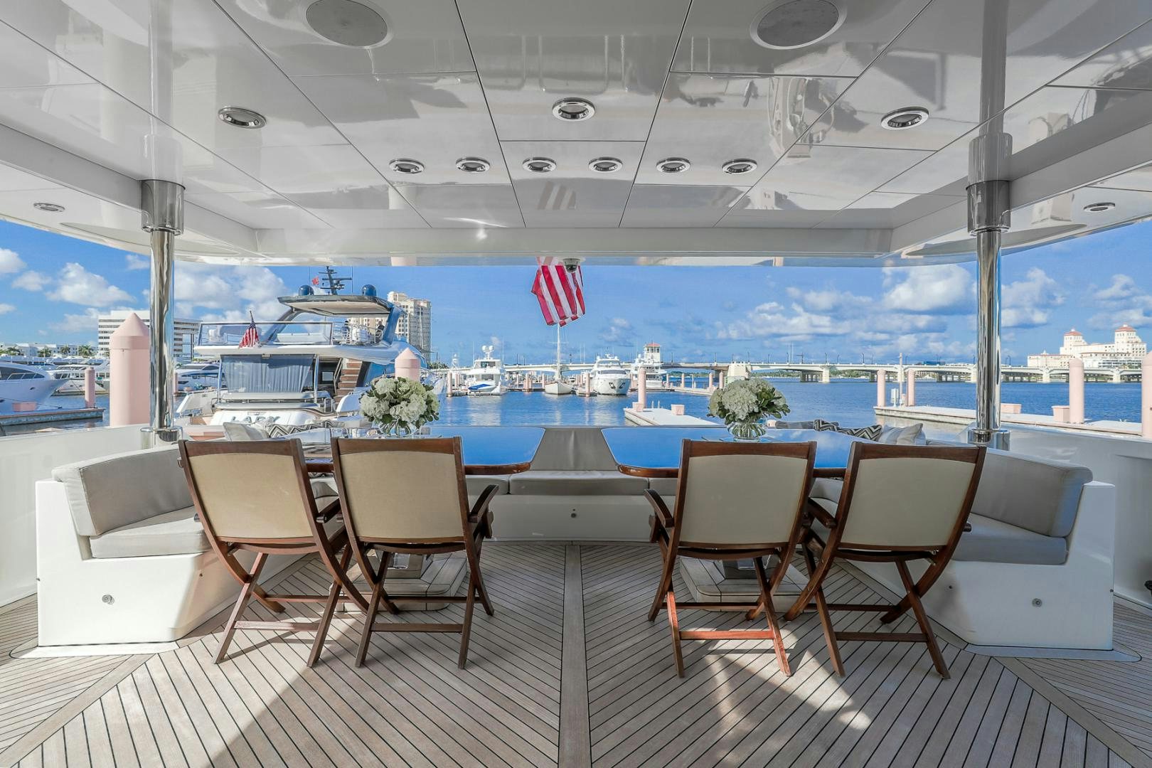a deck with chairs and a flag aboard FUGITIVE *NAME RESERVED* Yacht for Sale