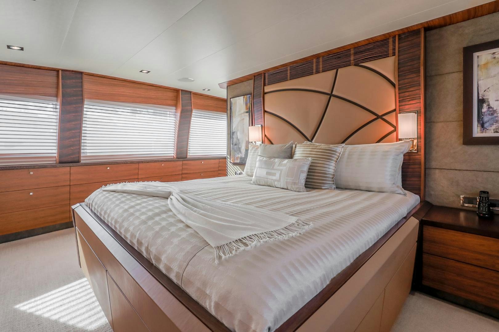 a bed with a white sheet and pillows aboard FUGITIVE *NAME RESERVED* Yacht for Sale